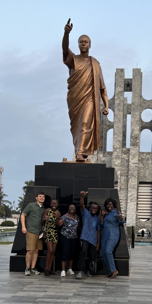 Pearl and her family in front of a statue of Dr. Kwame Nkrumah in Accra, Ghana.